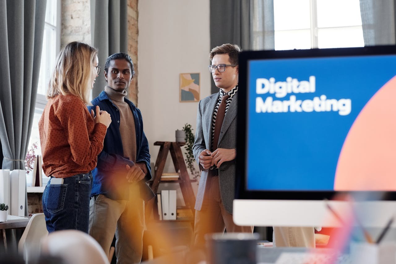 Offerings Group of colleagues discussing digital marketing strategies in an office setting.
